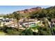 Aerial view of the property featuring a pool, patio area, meticulously landscaped yard, and mountain backdrop at 4633 N 49Th Pl, Phoenix, AZ 85018