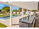 Outdoor patio with dining table, pool, and lush landscaping for outdoor living at 4633 N 49Th Pl, Phoenix, AZ 85018