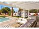Outdoor patio with lounge seating, outdoor kitchen, and a relaxing view of the pool and backyard at 4633 N 49Th Pl, Phoenix, AZ 85018