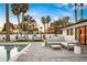 Charming backyard patio with outdoor kitchen, comfortable seating, and a view of the sparkling pool at 4633 N 49Th Pl, Phoenix, AZ 85018