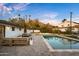 Relaxing backyard featuring a large pool, outdoor dining area, and comfortable lounge seating at 4633 N 49Th Pl, Phoenix, AZ 85018