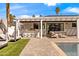 Inviting backyard features a covered patio, outdoor kitchen, lounge chairs, and sparkling pool at 4633 N 49Th Pl, Phoenix, AZ 85018