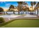 The backyard features a putting green, pool, lounge chairs, and fire pit, creating an outdoor oasis at 4633 N 49Th Pl, Phoenix, AZ 85018