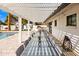 Covered patio with large dining table overlooking a pool and manicured backyard at 4633 N 49Th Pl, Phoenix, AZ 85018
