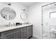 Bathroom featuring double vanity with marble countertops and modern lighting fixtures at 4633 N 49Th Pl, Phoenix, AZ 85018
