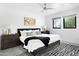 Spacious bedroom featuring a ceiling fan, modern decor, and plenty of natural light at 4633 N 49Th Pl, Phoenix, AZ 85018