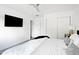 Bright bedroom with a ceiling fan, closet, and plush white bedding at 4633 N 49Th Pl, Phoenix, AZ 85018