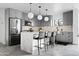 Modern kitchen featuring gray cabinets, stainless steel appliances, and a center island with bar seating at 4633 N 49Th Pl, Phoenix, AZ 85018
