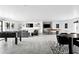 Expansive living area showcasing a modern aesthetic with recessed lights, game area, and comfortable seating at 4633 N 49Th Pl, Phoenix, AZ 85018