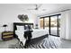 Stylish main bedroom with a king bed, modern decor, and access to the backyard through sliding glass doors at 4633 N 49Th Pl, Phoenix, AZ 85018
