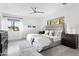 Bright main bedroom with a king bed, neutral decor, modern ceiling fan, and natural light from large windows at 4633 N 49Th Pl, Phoenix, AZ 85018