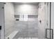 Walk-in shower with glass doors, marble-look tile, bench, and recessed niche for toiletries at 4633 N 49Th Pl, Phoenix, AZ 85018