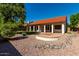 Backyard with decorative rock landscaping, a tiled roof, a covered patio, and established trees, ideal for relaxing at 5517 W Aster Dr, Glendale, AZ 85304