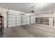 Spacious two car garage with ample room for parking and storage with an automatic door and shelving at 5517 W Aster Dr, Glendale, AZ 85304