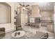 Bright, staged kitchen featuring an island with bar seating, a breakfast nook, and modern appliances at 5517 W Aster Dr, Glendale, AZ 85304