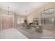 Bright living room with high ceilings, natural light, neutral paint, tile entry, and carpet at 5517 W Aster Dr, Glendale, AZ 85304