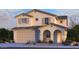Inviting two-story home featuring a neutral color palette, attached two-car garage, and a covered front entryway at 5848 S Hassett Ave, Mesa, AZ 85212