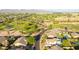 Expansive aerial view overlooking lush golf course and community with mountain backdrop, blue sky, and surrounding landscaping at 6435 E Monte Cristo Ave, Scottsdale, AZ 85254