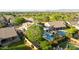 An aerial view captures a property near a park, boasting a pool, patio, and manicured greenery for outdoor enjoyment at 6435 E Monte Cristo Ave, Scottsdale, AZ 85254