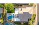 Aerial view of an impeccably landscaped property, featuring a pool, patio, green lawn, and a well-maintained roof at 6435 E Monte Cristo Ave, Scottsdale, AZ 85254