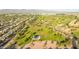 Picturesque aerial view of well-manicured park, lush golf course, community, and majestic mountain backdrop on clear, blue-sky day at 6435 E Monte Cristo Ave, Scottsdale, AZ 85254