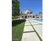 Expansive backyard featuring pavers with grass accents and swimming pool, ideal for outdoor enjoyment at 6435 E Monte Cristo Ave, Scottsdale, AZ 85254