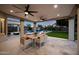 Inviting backyard patio featuring a dining area, ceiling fans, and views of the pool and landscaped yard at 6435 E Monte Cristo Ave, Scottsdale, AZ 85254