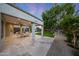 Spacious covered patio perfect for outdoor dining, overlooking the lush green lawn and sparkling pool at 6435 E Monte Cristo Ave, Scottsdale, AZ 85254