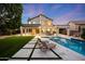 Gorgeous backyard featuring a sparkling pool, spacious patio, and well-manicured lawn, ideal for outdoor entertaining at 6435 E Monte Cristo Ave, Scottsdale, AZ 85254