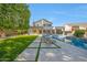 A stunning backyard with a pool, spa, covered patio and lush green lawn, perfect for outdoor living at 6435 E Monte Cristo Ave, Scottsdale, AZ 85254