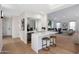 Elegant bar with bar stool seating, custom cabinets, wine cooler, and hardwood flooring at 6435 E Monte Cristo Ave, Scottsdale, AZ 85254
