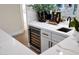 Wet bar with a white countertop, wine fridge, sink and decorative accents at 6435 E Monte Cristo Ave, Scottsdale, AZ 85254