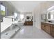 This luxurious bathroom features a glass-enclosed shower, soaking tub, and dual vanity sinks with modern fixtures at 6435 E Monte Cristo Ave, Scottsdale, AZ 85254