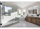 The spa-like bathroom features a glass enclosed shower and soaking tub along with modern fixtures at 6435 E Monte Cristo Ave, Scottsdale, AZ 85254