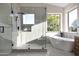 Bright bathroom with glass shower and soaking tub with natural light at 6435 E Monte Cristo Ave, Scottsdale, AZ 85254