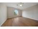 Unfurnished bedroom with hardwood flooring, neutral paint, and a arched window providing natural light at 6435 E Monte Cristo Ave, Scottsdale, AZ 85254