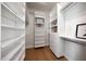 Spacious walk-in closet with custom shelving and wood flooring provides ample storage and organization at 6435 E Monte Cristo Ave, Scottsdale, AZ 85254