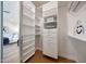 Custom closet with built-in shelving and drawers, plus a glimpse into the serene bedroom at 6435 E Monte Cristo Ave, Scottsdale, AZ 85254