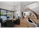 Modern dining room with chandelier, hardwood floors, and a view of the open floor plan at 6435 E Monte Cristo Ave, Scottsdale, AZ 85254