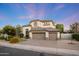 Elegant two-story home with three-car garage, lush landscaping, and a well-maintained lawn offers curb appeal at 6435 E Monte Cristo Ave, Scottsdale, AZ 85254