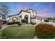 Charming two-story home with mature landscaping, arched entryway, and three-car garage offers timeless elegance at 6435 E Monte Cristo Ave, Scottsdale, AZ 85254