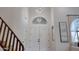 Welcoming foyer features double doors, modern lighting, and staircase at 6435 E Monte Cristo Ave, Scottsdale, AZ 85254
