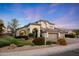 Beautifully landscaped front yard showcases a charming two-story home with a three-car garage and well-maintained lawn at 6435 E Monte Cristo Ave, Scottsdale, AZ 85254