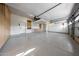 Spacious three-car garage features epoxy flooring, custom cabinetry, and ample storage space at 6435 E Monte Cristo Ave, Scottsdale, AZ 85254
