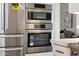 Modern kitchen with stainless steel Bosch appliances, including refrigerator, oven, and microwave at 6435 E Monte Cristo Ave, Scottsdale, AZ 85254