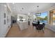 Contemporary kitchen with stainless steel appliances, white cabinets, a marble island, and an adjacent dining area at 6435 E Monte Cristo Ave, Scottsdale, AZ 85254