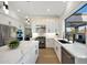 Bright kitchen featuring stainless steel appliances, white cabinets, a large island, and ample counter space at 6435 E Monte Cristo Ave, Scottsdale, AZ 85254