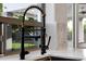 Modern kitchen faucet with a sleek design, complemented by natural light from the window at 6435 E Monte Cristo Ave, Scottsdale, AZ 85254
