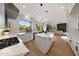 Modern kitchen with stainless appliances, stone countertops, open layout to a cozy living room with a fireplace at 6435 E Monte Cristo Ave, Scottsdale, AZ 85254