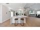 Open-concept kitchen and living area with a sleek white countertop and barstool seating at 6435 E Monte Cristo Ave, Scottsdale, AZ 85254